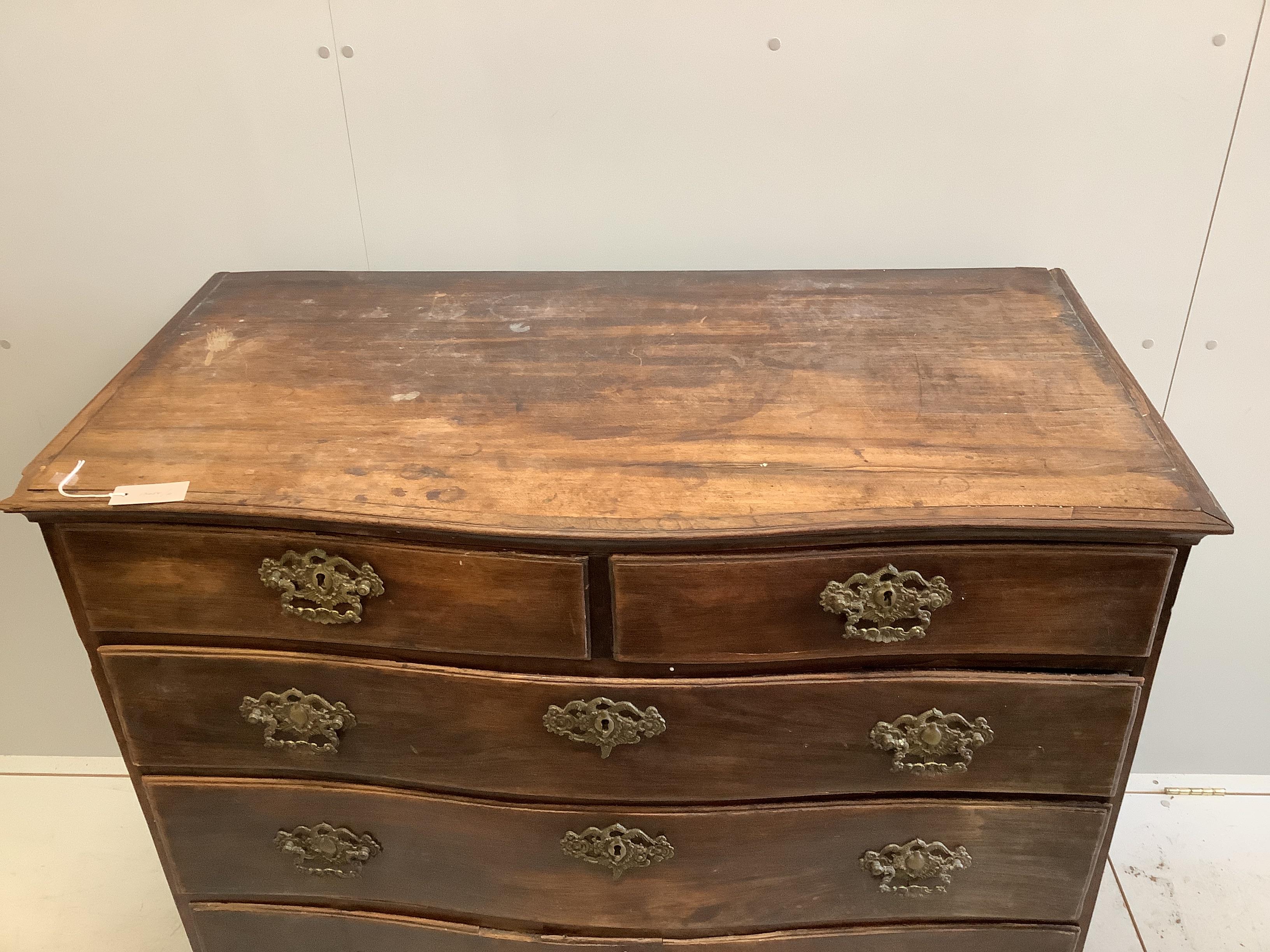 An 18th century Continental rosewood serpentine four drawer chest (missing back foot), width 120cm, depth 62cm, height 103cm